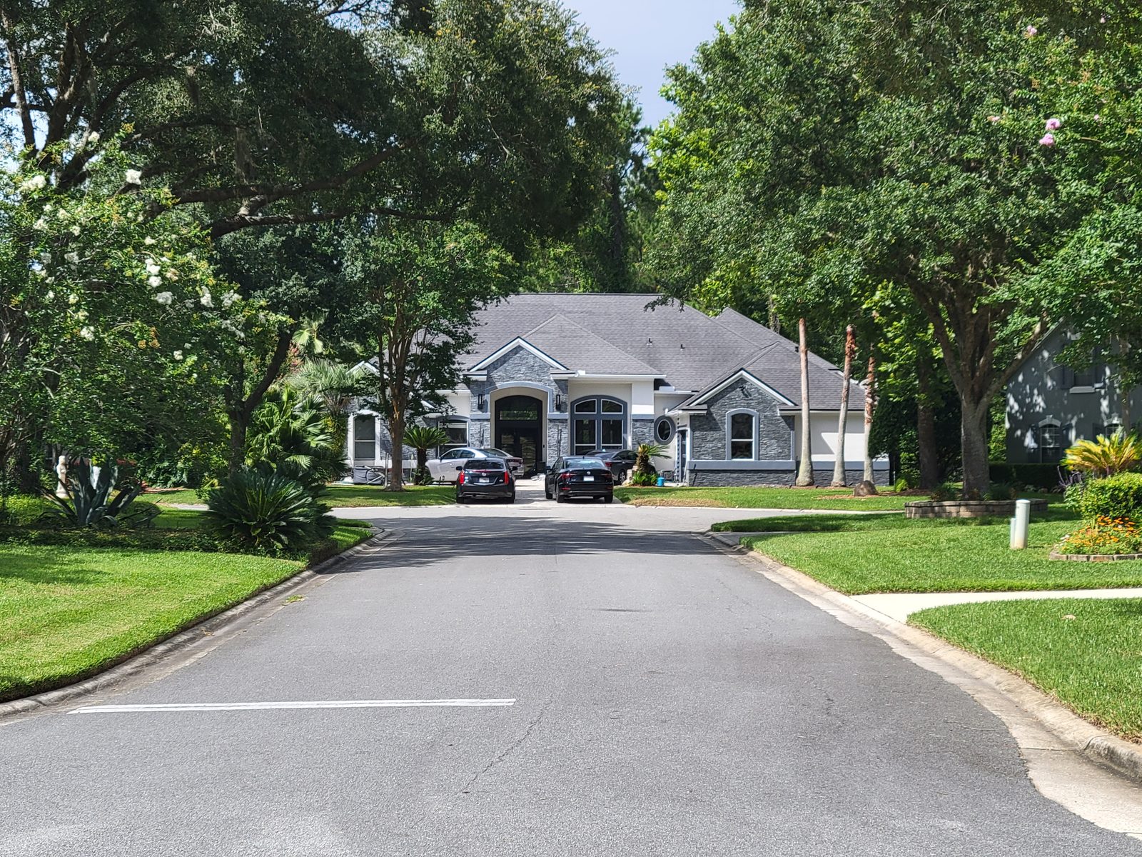 Tree lined residential street with green lawns in Jacksonville, Duval County, Florida